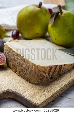 Piece Of French Cheese Tomme De Brebis Made From Sheep Milk Served As Dessert With Fresh Figs And Pe