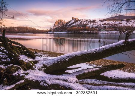 Snow Covered Devin Castle Ruins Above The Danube River In Bratislava, Slovakia At Sunrise