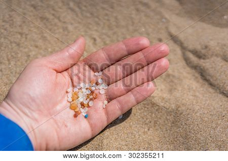 Woman Holding Small Tiny Harmful Plastic Beads Collected On The Beach In Zante, Zakynthos, Greece