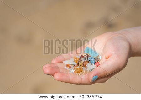 Little Girl Holding Small Tiny Harmful Plastic Beads Collected On The Beach In Zante, Zakynthos, Gre