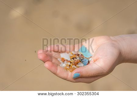 Little Girl Holding Small Tiny Harmful Plastic Beads Collected On The Beach In Zante, Zakynthos, Gre