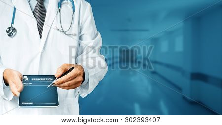 Doctor With Stethoscope Holds In His Hand Tablet With History Of The Disease And Pen For Digital Sig