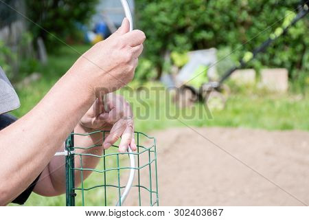 Gardening Handman Working In Garden To Preparing Garden With Cutting,and Tight Plastic With Grill To
