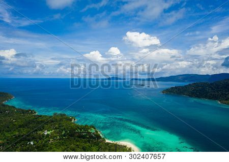 Aerial drone view of beautiful green Koh Usen island with amazing lagoon sea over summer sky background, Thailand