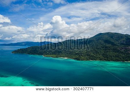 Aerial drone view of beautiful green Koh Usen island with amazing lagoon sea over summer sky background, Thailand