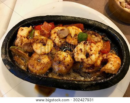 Shrimp Casserole Cooked With Butter And Bitten Bread At Restaurant. Organic Fish Food Served At Rest