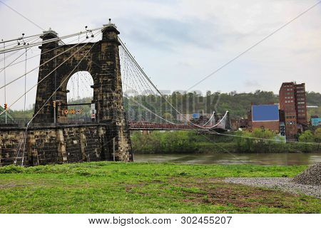 The Wheeling Suspension Bridge, originally built in 1849, spans the Ohio river along the route 40 National Road.