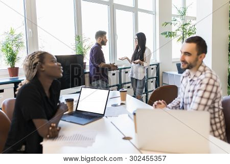 Diverse Colleagues Sitting Talking On Business Training With Coach, Multiracial Team Employees Discu