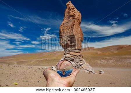 Left Hand Holding Crystal Ball In Atacama Pacana Monks