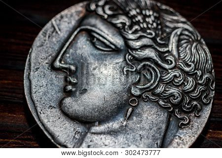 Russia - March 2019: Souvenir Coin With The Image Of The Face Of The Ancient Greek Close-up. Copy Of