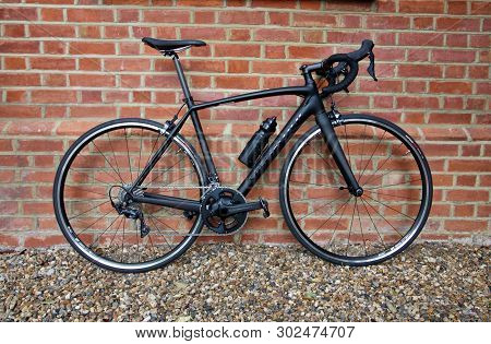 28 April 2019 - London, United Kingdom: Stylish Black Bicycle Standing Against Weathered Brick Wall