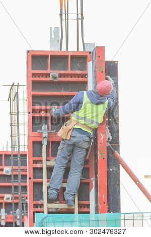 An Engineer Is Climbing Up The Stairs At The Constraction Site