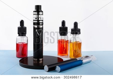 Electronic Cigarettes And Glass Bottles With Vape Liquid On White Background