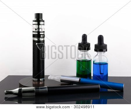 Electronic Cigarettes And Glass Bottles With Vape Liquid On White Background