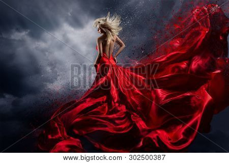 Woman In Red Dress Dance Over Storm Sky, Gown Fluttering Fabric Flying As Splash