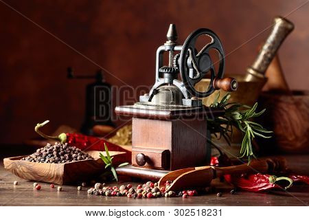 Vintage Pepper Mill With Various Peppers And Spices. Old Pepper Mill With Kitchen Utensils, Spices A