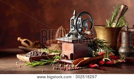 Vintage Pepper Mill With Various Peppers And Spices. Old Pepper Mill With Kitchen Utensils, Spices A