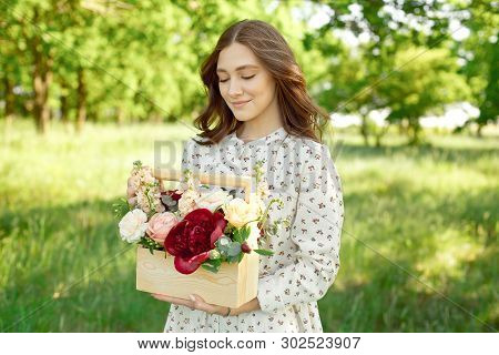 Half Portrait Of A Charming Positive Woman Dressed In Long White Summer Dresses With A Happy Smile O