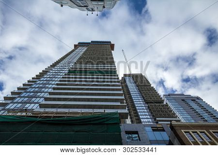 Cranes And Building Device On A Construction Site Of A Skyscraper In Downtown Toronto, Surrounded By