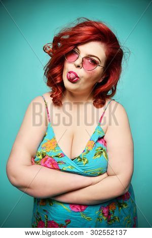 Impish Playful Plus-size Lady Overweight Fat Woman In Sunglasses And Summer Clothes With Arms Crosse