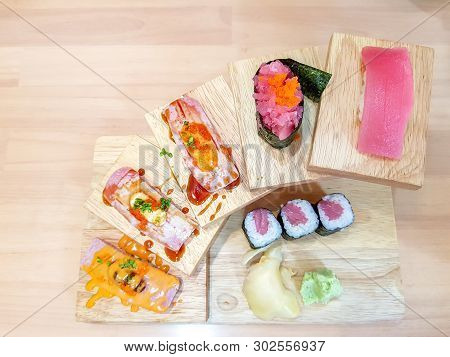 Makuro Sushi Or Nigri Set  And Maki Served On The Wooden Stair Shape Dish.