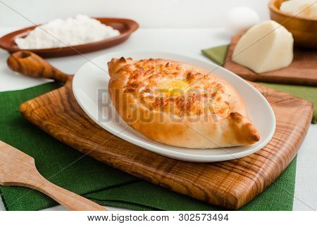 Ajar-style Khachapuri With Cottage Cheese And Egg Yolk. Home Cooking Food Photography In Warm Tones.