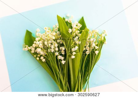 Bouquets Of Lily Of The Valley On A Blue Background. Romantic Postcard.
