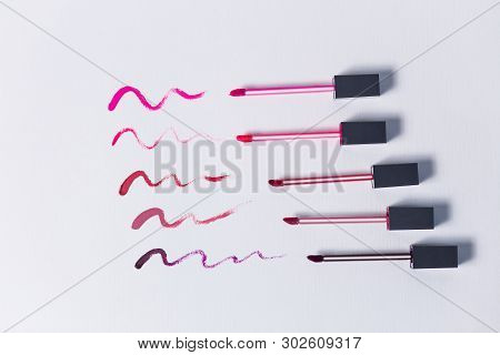 Smudged Red, Pink, Burgundy Lipstick Isolated On White
