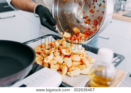 Cooking Fried Potatoes With Sweet Pepper On The Culinary Master Class. Potatoes Spread On A Baking S