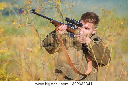 Man Aiming Target Nature Background. Aiming Skills. Hunter Hold Rifle. Hunting Permit. Bearded Hunte