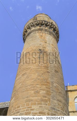 View From Below On Mosque Cuma In Old City Baku With Clear Blue Sky Background