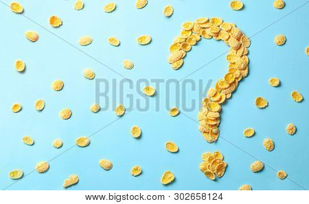 Yellow Flakes In The Shape Of A Question Mark On A Blue Background. How To Choose Cereal For Breakfa