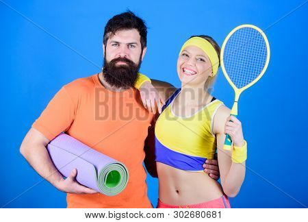 Sporty Couple Training With Fitness Mat And Tennis Racket. Sport Equipment. Athletic Success. Happy 