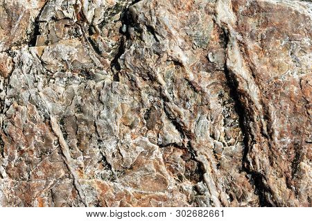 Macro View Of Cracked Stone Surface Brown And Grey Color. Detailed Nature Background Or Pattern Text