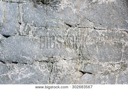 Close-up Macro View Of Rough Stone Surface Grey Color. Detailed Nature Background Or Pattern Texture