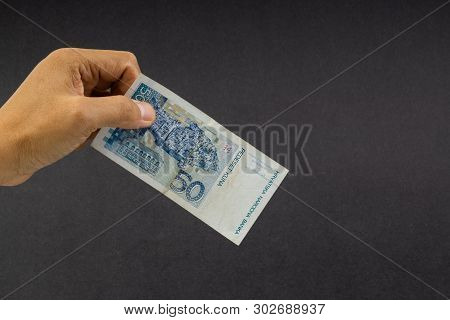 Hand Holding Fifty Croatian Kuna Or Sto Kuna Bank Notes On Black Background. Financial Concept And S