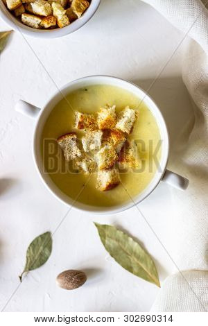 Cheese Cream Soup On A White Background. White Bread Croutons. Ingredients.