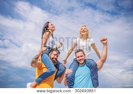 Twice Fun On Double Date. Couples In Love Having Fun. Men Carry Girlfriends On Shoulders. Summer Vac