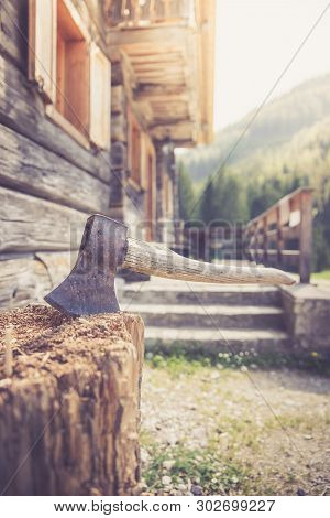 Getting Wood For Fire: Axe Attached To A Tree Trunk