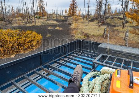 Travel On The Roof Of A Truck. Leg In A Trapper Boots. Equipment Off Road Expedition, Rope And Yello