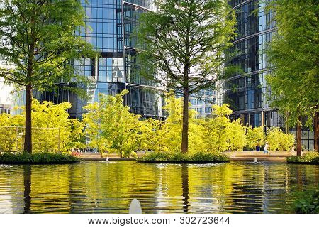 modern office building is reflected on the mirror surface