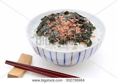 Japanese Food, Cooked Rice With Furikake Of Shake And Nori On Black Background