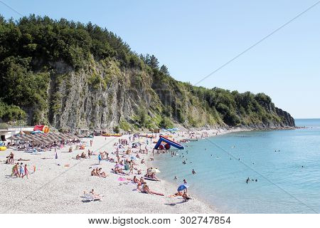 Olginka, Russia - May 24, 2019: Holidaymakers On The Beach, Olginka Village, Tuapse, The Black Sea, 