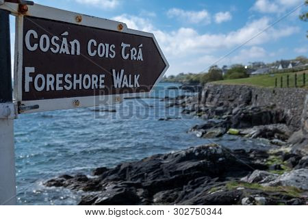 A Foreshore Walk Sign In English And Irish, Pointing To The Walk Along The Jagged Cliff With The Atl
