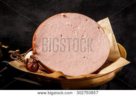 Closeup Big Piece Of Boiled Sausage On Piece Of Craft Paper