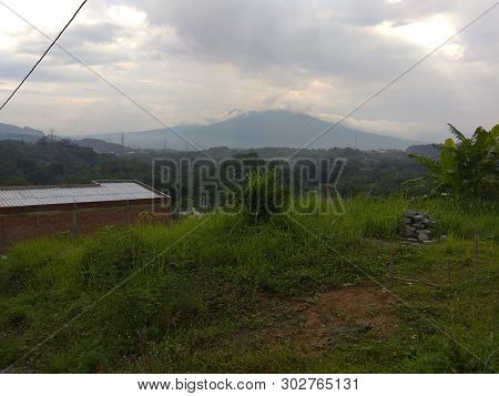 Beautiful Landscape With Mountain And Green Grass