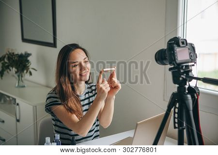 Girl Videoblogger Or Beauty Blogger Records Video For Subscribers. She Shows Lipstick And Tells How 