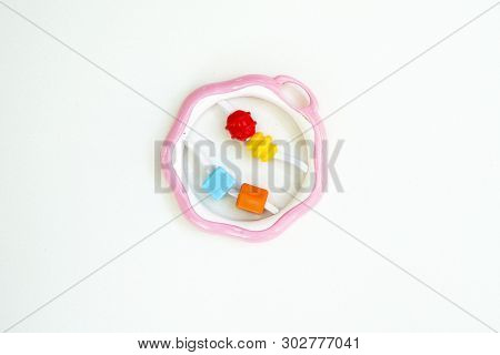 Newbor Toy. A Colorful Baby Rattle On A White Horizontal Background
