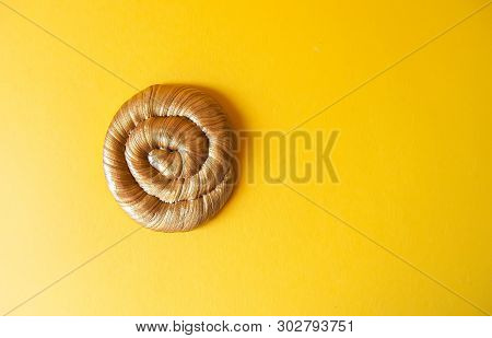 Golden Plasticine Soft Stretchable Texture On Yellow Background. Anti-stress Toy For Kids Activities