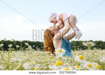 Mother With A Child In Nature Summer